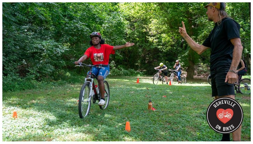 Teenager learning to ride, signaling left turn